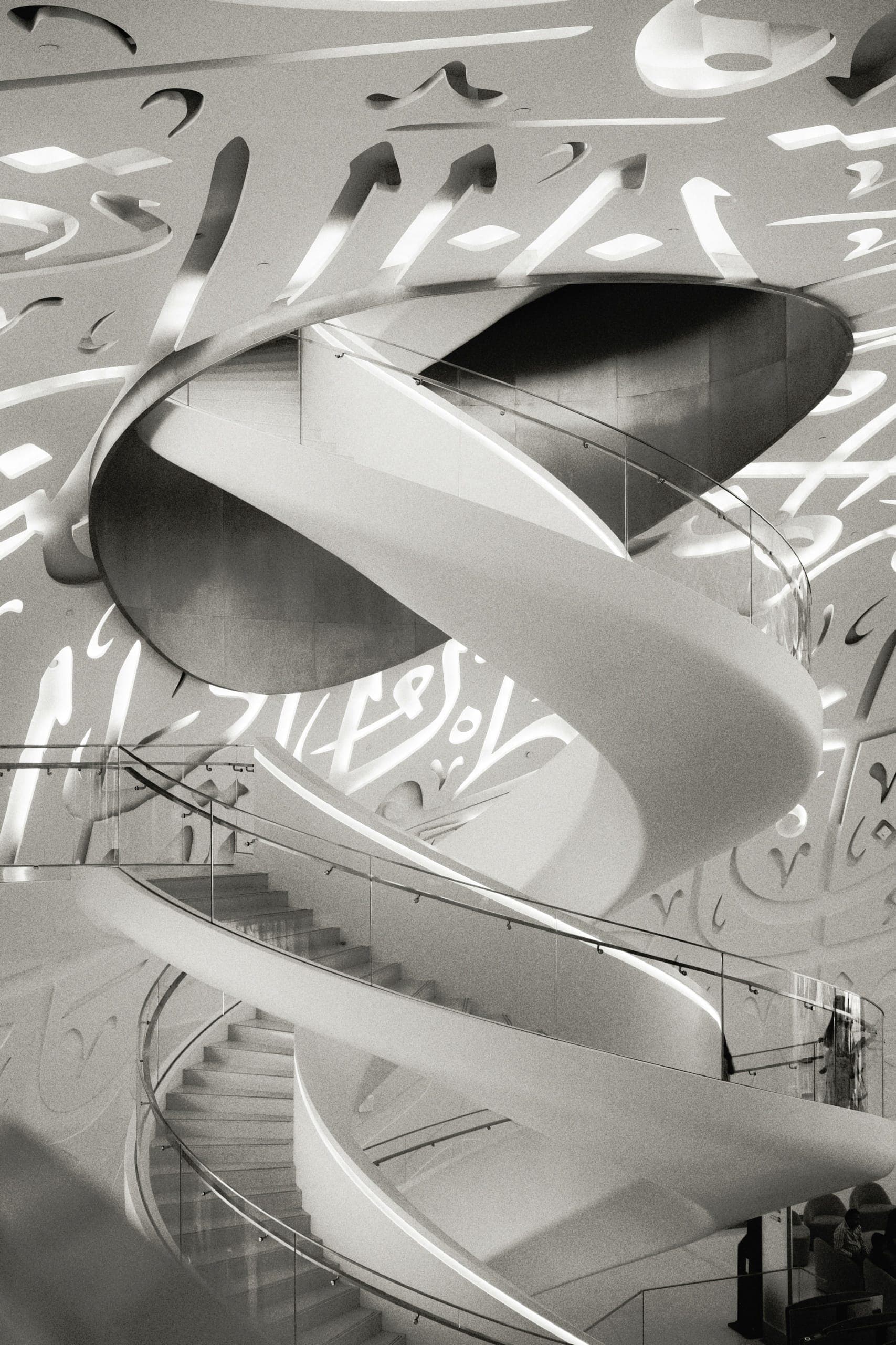 Architectural spiral staircase with Arabic calligraphy, reflecting Innavera's roots bridging East and West